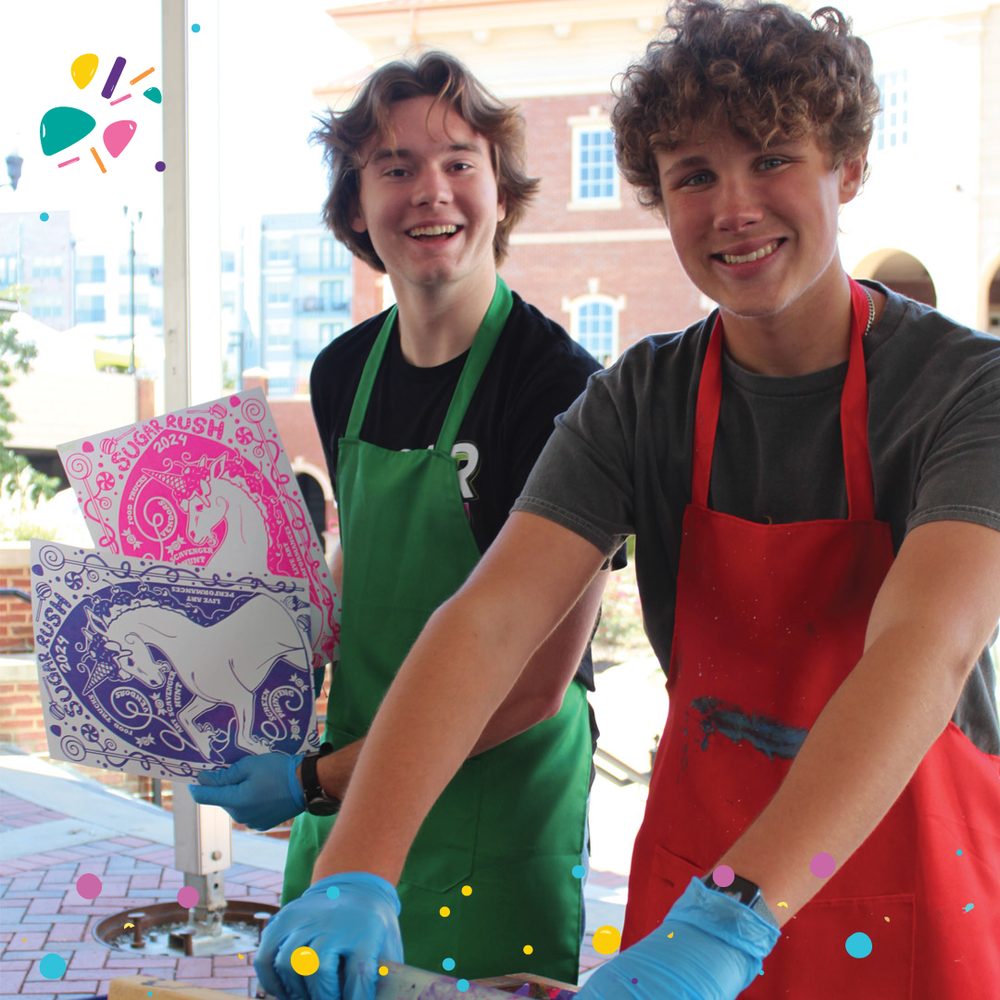 Young artists making spin art at the festival