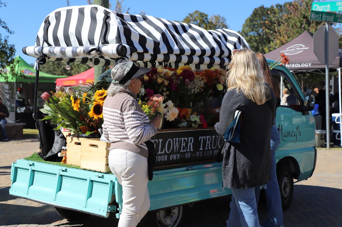 Shoppers at the flower truck booth